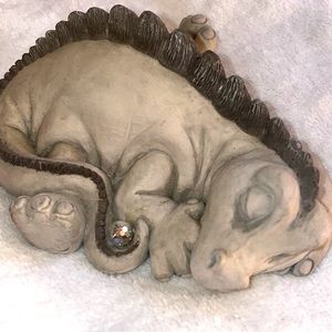 Krystonia sleeping dragon holding a crystal ball in tail.